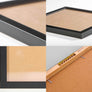 Black framed artwork wood detail and brass hangings